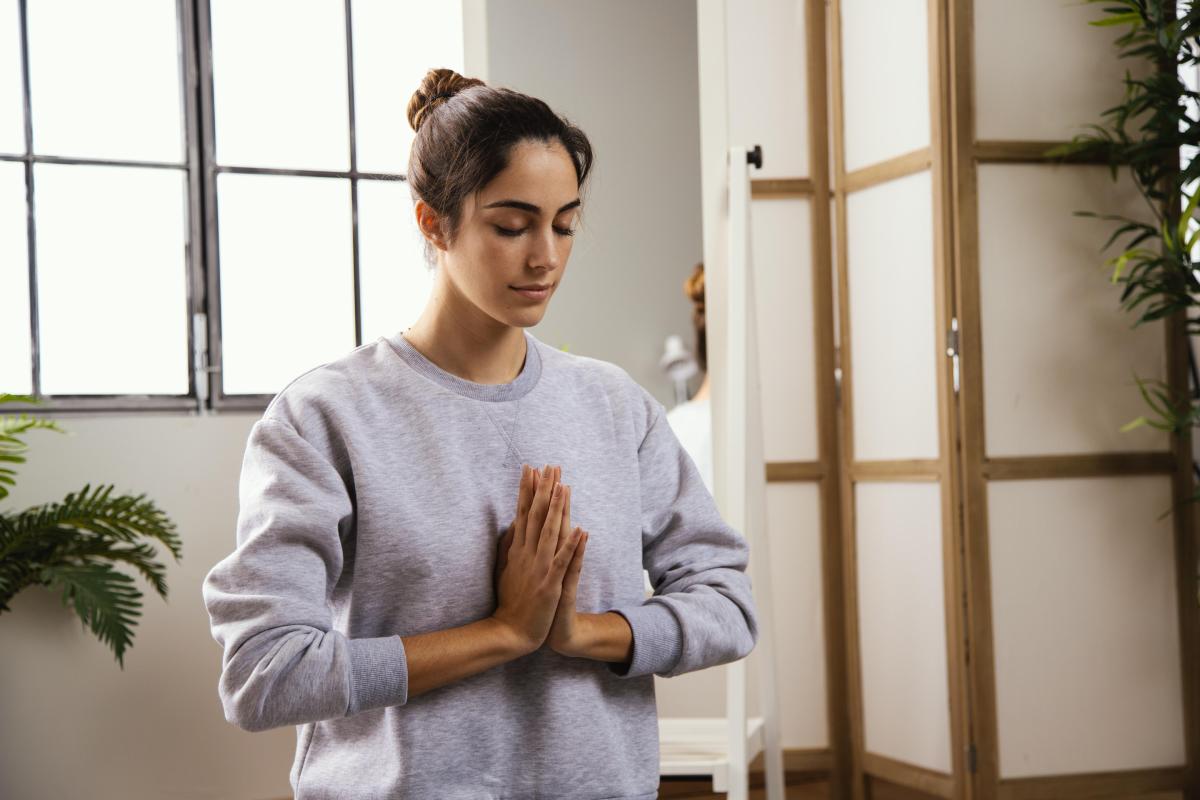 Young woman doing yoga home.